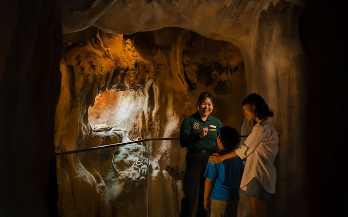 Ranger giving a talk to visitors inside a cavern at Rainforest Wild Adventure.
