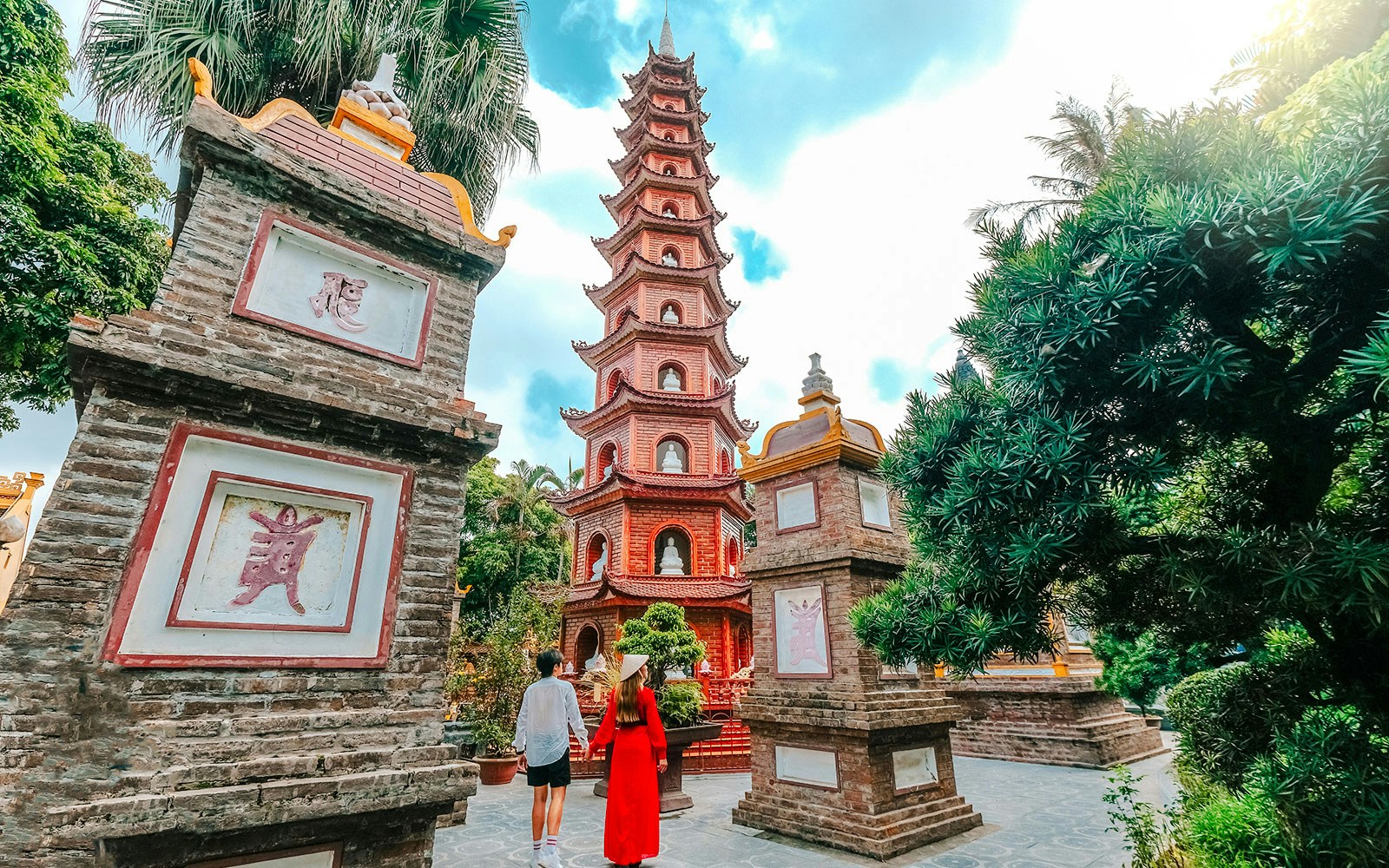 Tran Quoc Pagoda in Hanoi with visitors exploring the temple grounds.