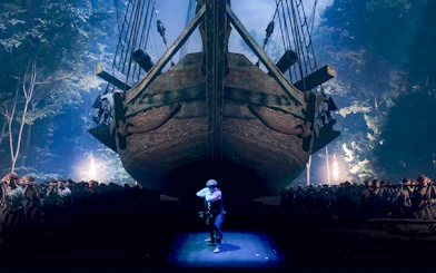 Performers in action at Legends of Istanbul with a large ship backdrop.