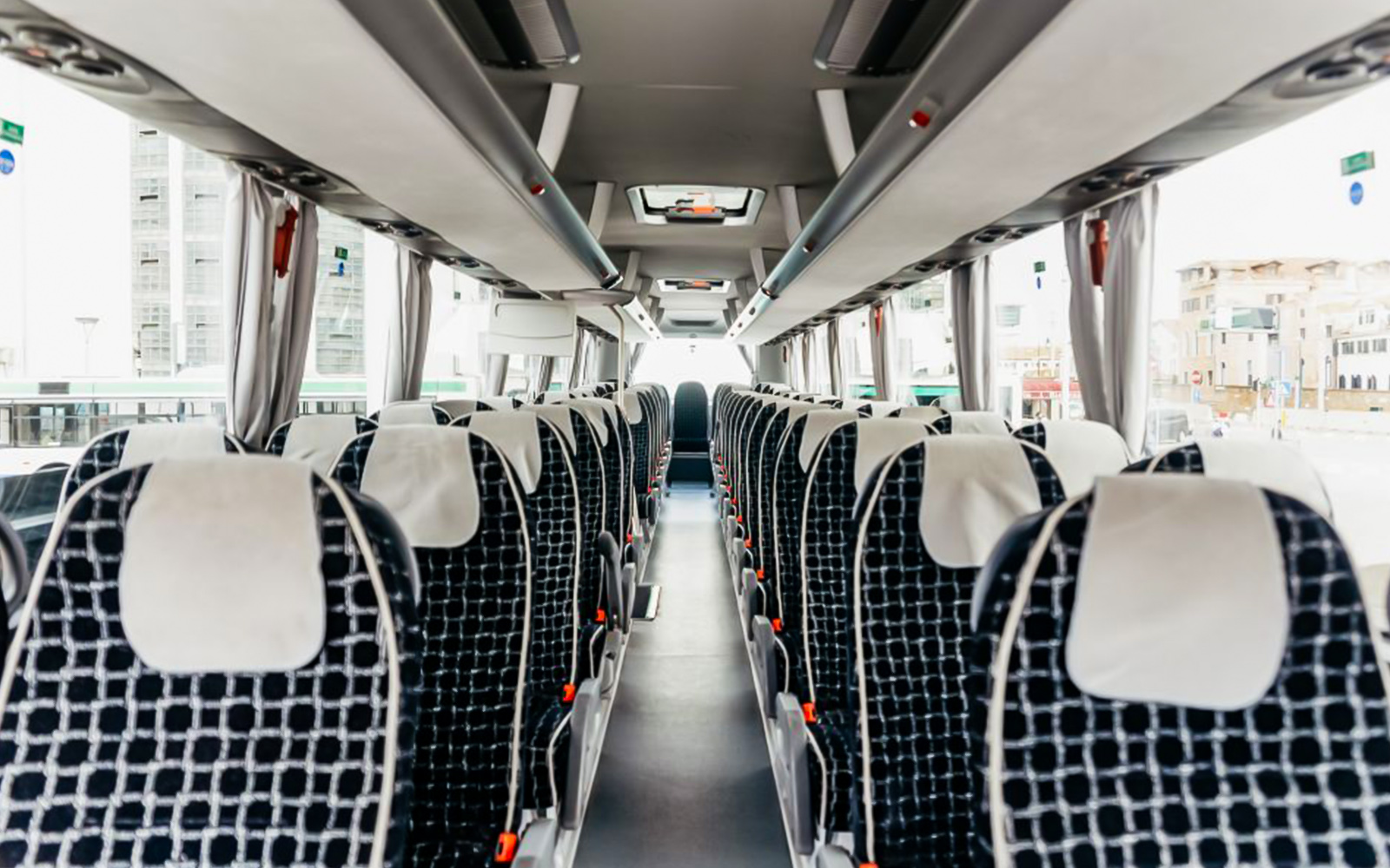 Interior of ATVO Airport transfer bus with rows of empty seats.
