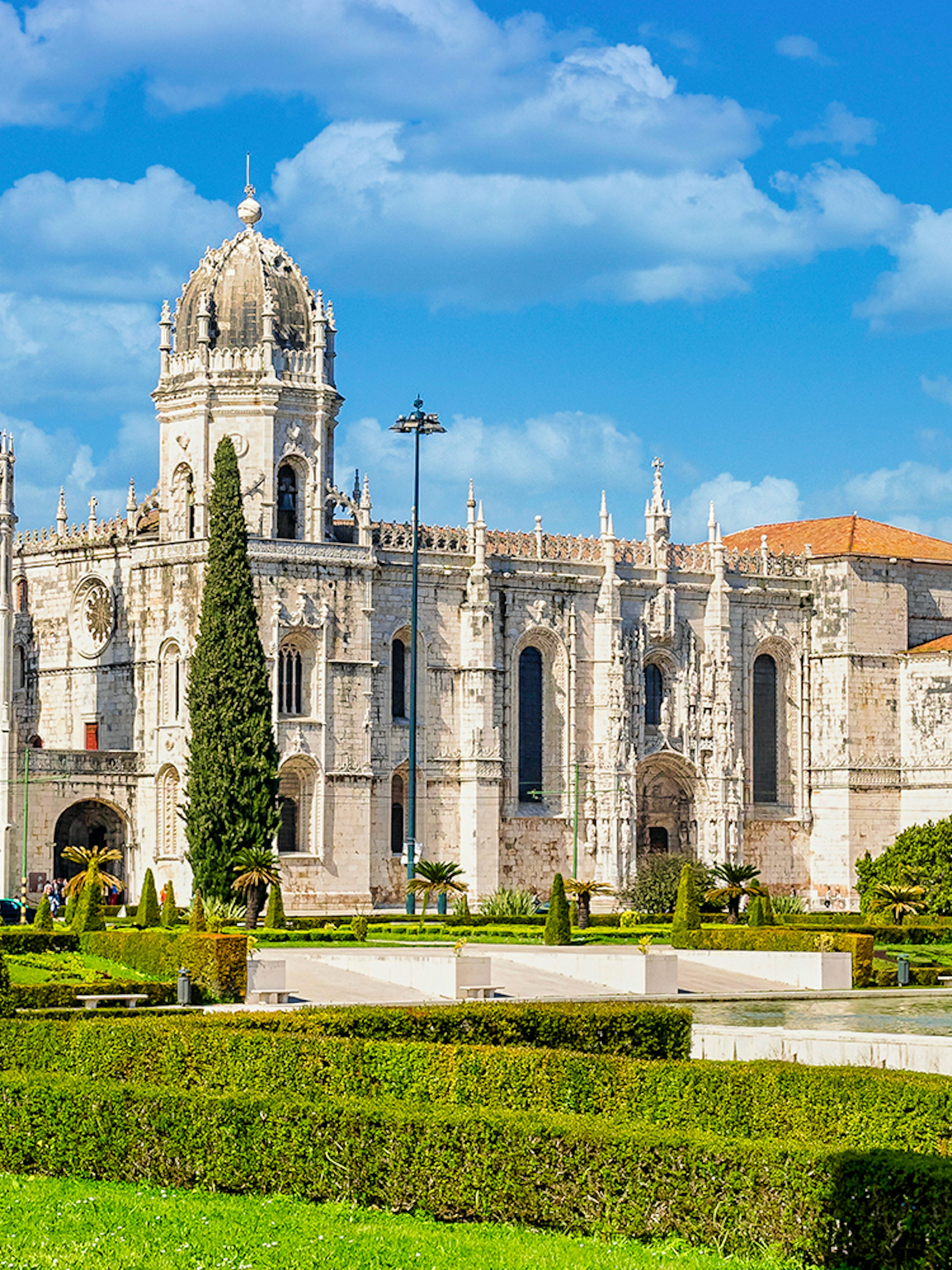 Jernimos Monastery front view with gardens in Lisbon, Portugal.