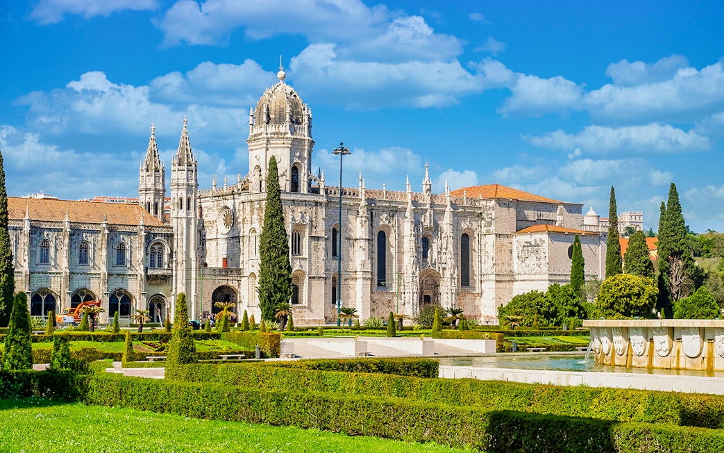 Jernimos Monastery front view with gardens in Lisbon, Portugal.