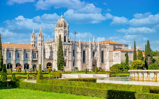 Jernimos Monastery front view with gardens in Lisbon, Portugal.