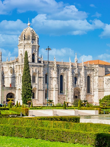 Jernimos Monastery front view with gardens in Lisbon, Portugal.