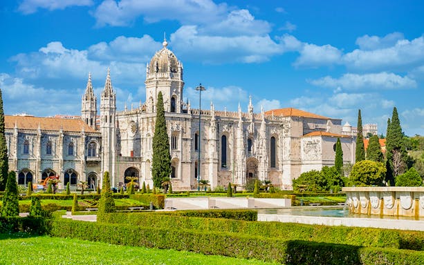 Jernimos Monastery front view with gardens in Lisbon, Portugal.
