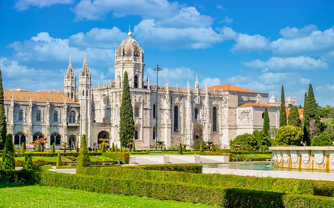 Jernimos Monastery front view with gardens in Lisbon, Portugal.
