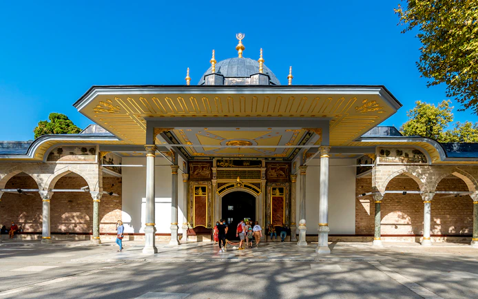 Gate of Felicity at Topkapi Palace, Istanbul, with visitors exploring the historic entrance.