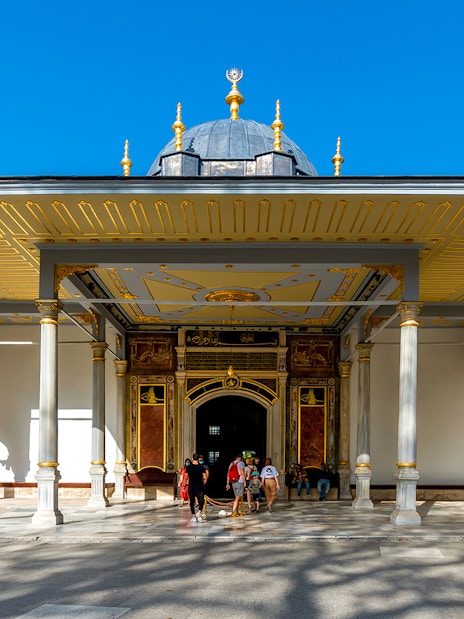 Gate of Felicity at Topkapi Palace, Istanbul, with visitors exploring the historic entrance.