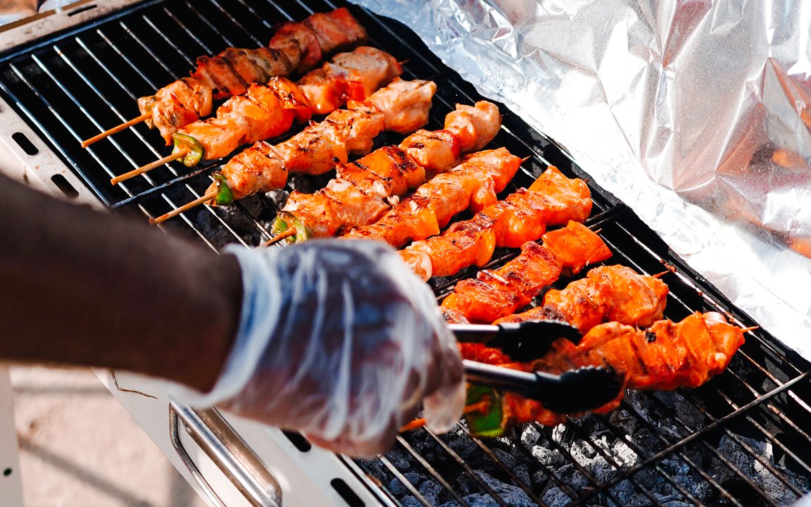 Grilling skewers on a BBQ during a luxury yacht cruise in Dubai.