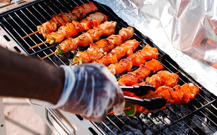 Grilling skewers on a BBQ during a luxury yacht cruise in Dubai.