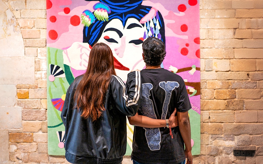 Visitors admiring colorful artwork at Moco Museum, Barcelona.
