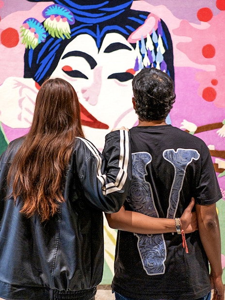 Visitors admiring colorful artwork at Moco Museum, Barcelona.