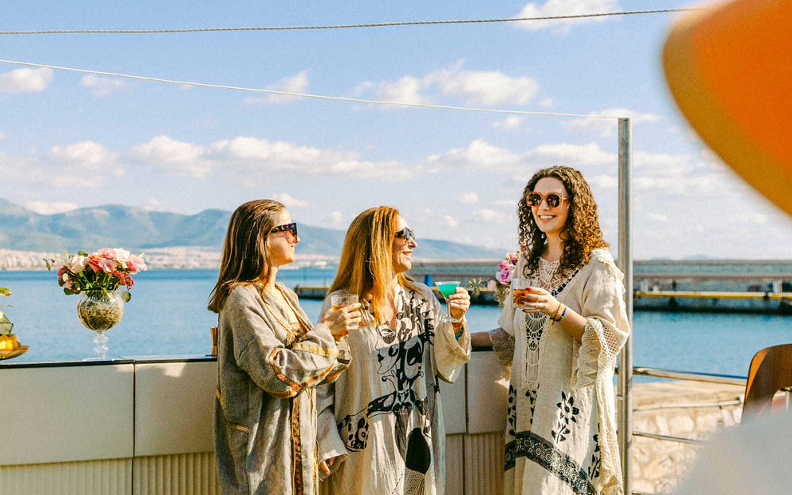 Three women enjoying a half-day Saronic Gulf cruise near Piraeus, Greece.