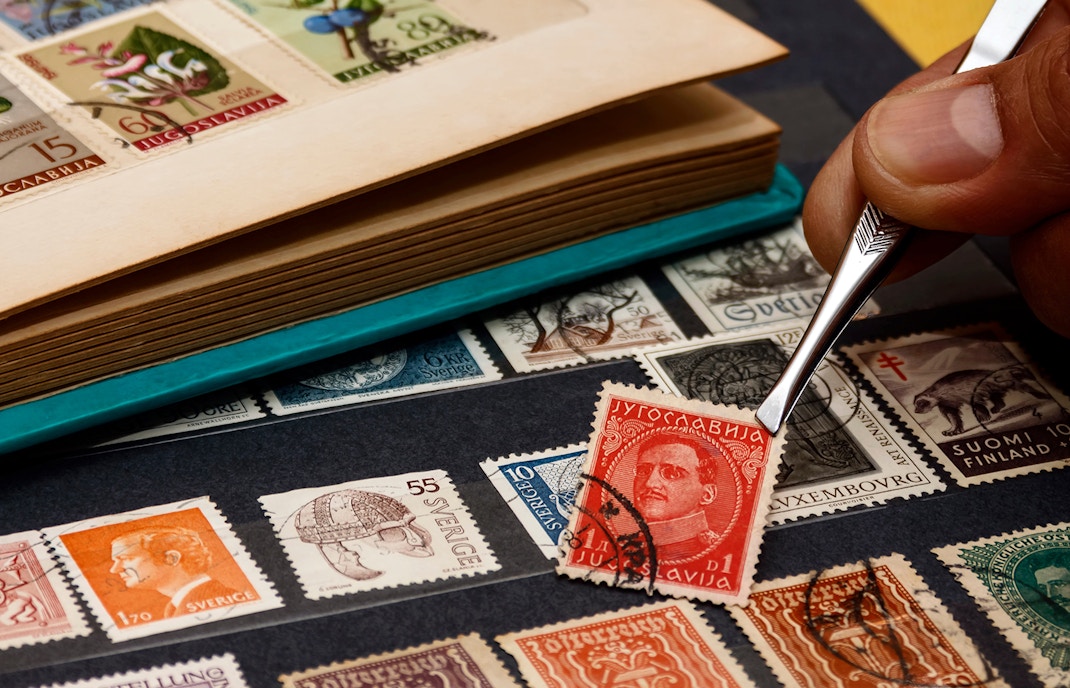 Stamps being arranged with tweezers