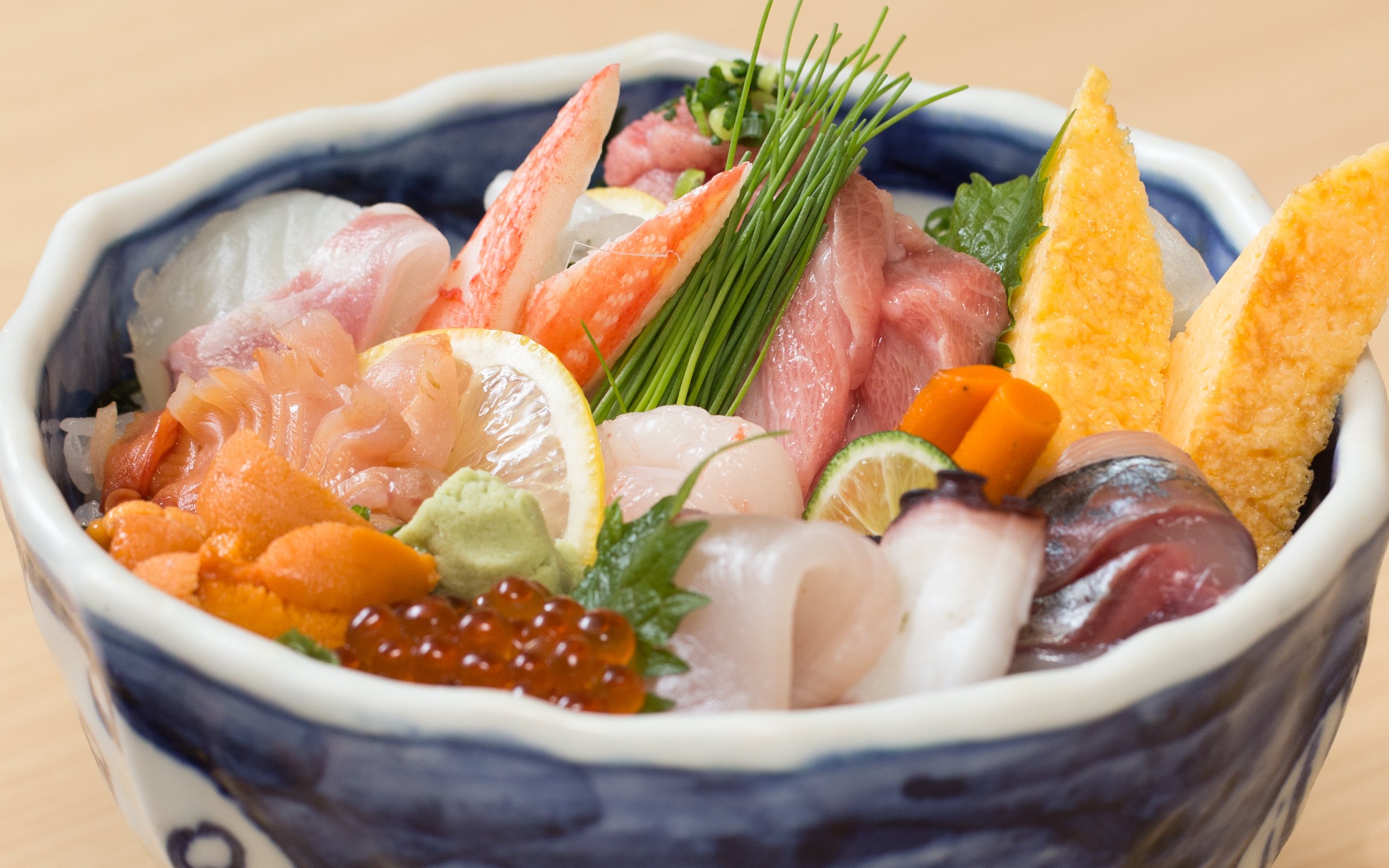 Fresh raw fish rice bowl with sashimi and garnishes in Japan.