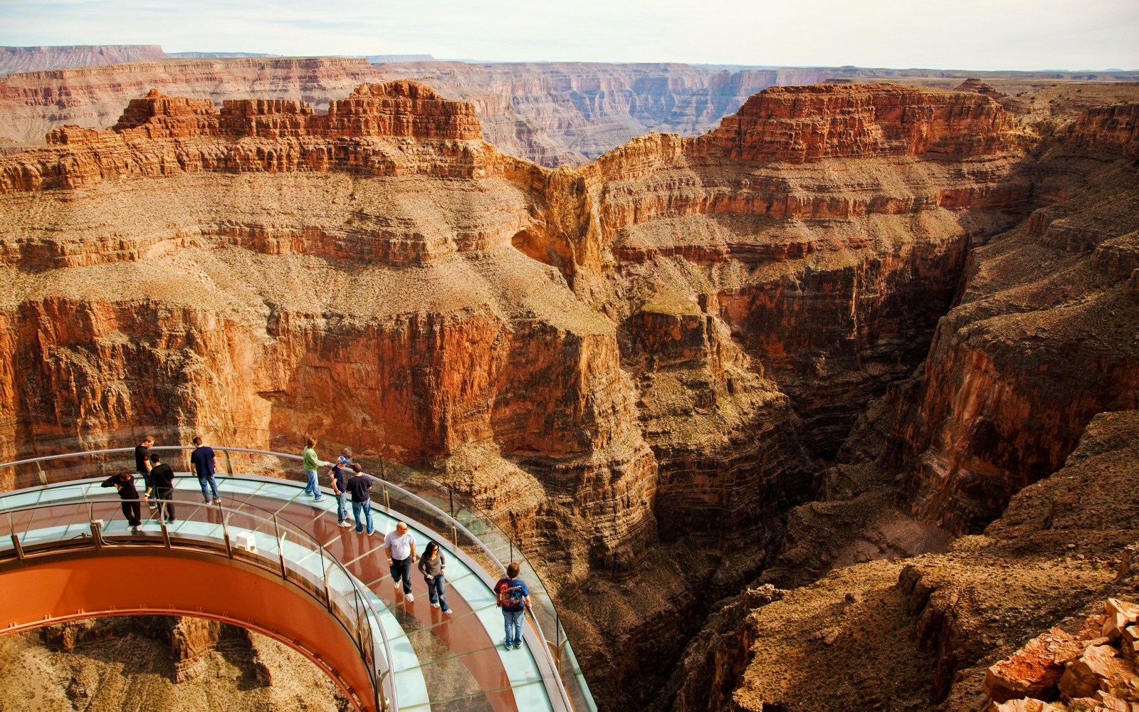 Grand Canyon Skywalk with visitors on glass bridge over canyon.