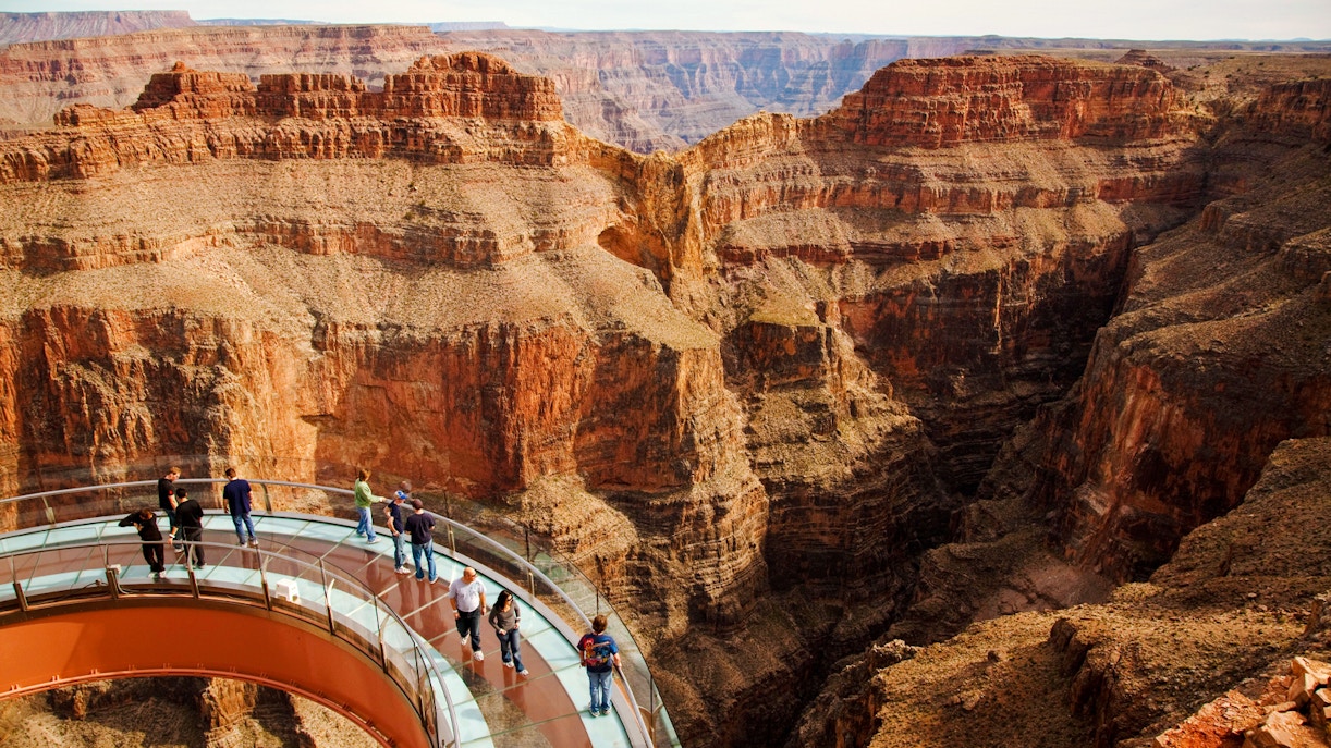 Grand Canyon Skywalk with visitors on glass bridge over canyon.