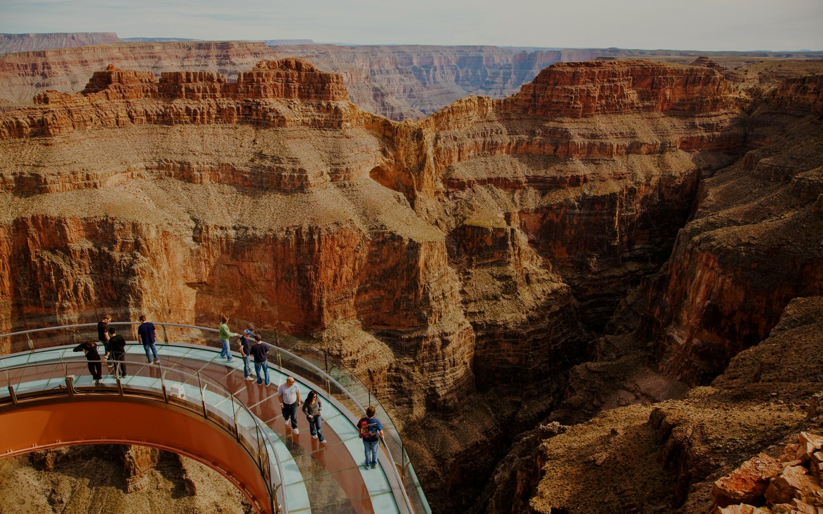 Grand Canyon Skywalk with visitors on glass bridge over canyon.
