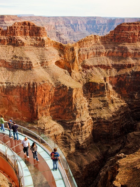 Grand Canyon Skywalk with visitors on glass bridge over canyon.