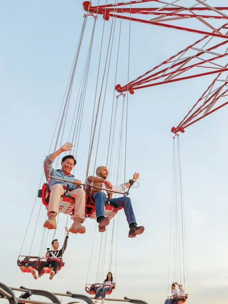 Tourists riding SkyFlyers swing at Asiatique Bangkok.