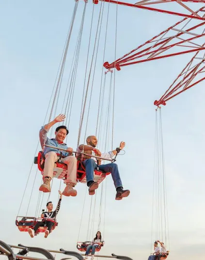 Tourists riding SkyFlyers swing at Asiatique Bangkok.