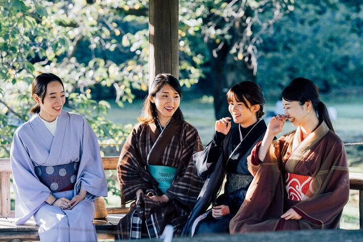 Tourists in kimonos enjoying Tokyo Matcha & Kimono Experience outdoors.