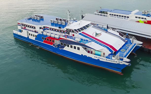 Langkawi ferry docked at the pier with passengers boarding, Malaysia.