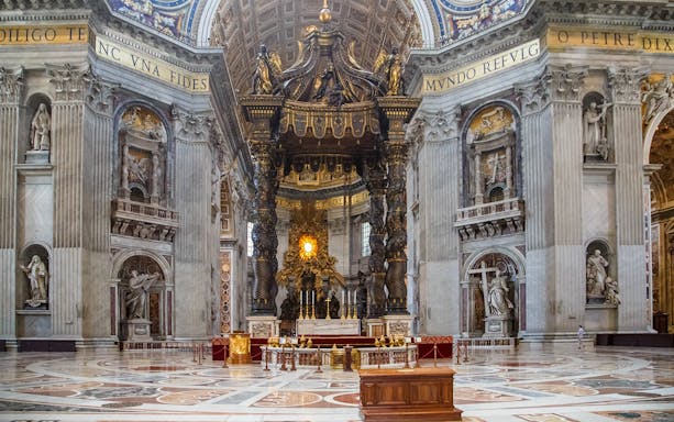 St. Peter’s Basilica interior with ornate altar and sculptures, Vatican City.