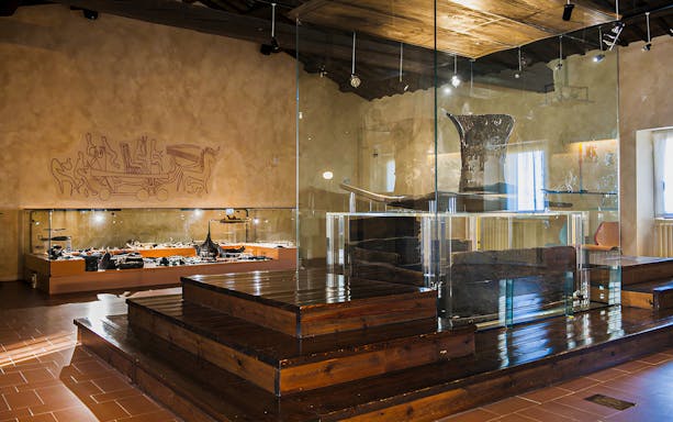 San Leo Fortress museum exhibit with ancient artifacts and wall carvings.
