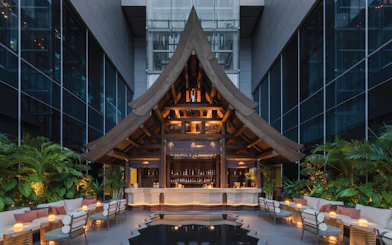 Rooftop bar with wooden architecture at Akara Sky Hanuman, One City Centre, Bangkok.