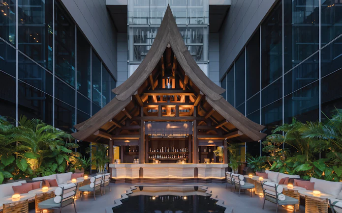 Rooftop bar with wooden architecture at Akara Sky Hanuman, One City Centre, Bangkok.