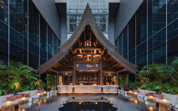 Rooftop bar with wooden architecture at Akara Sky Hanuman, One City Centre, Bangkok.