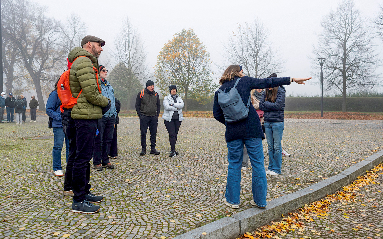 Tour guide explaining to tourists during Terezin Concentration Camp tour.