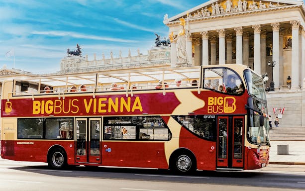 Open-top Big Bus in front of Vienna's Parliament Building.