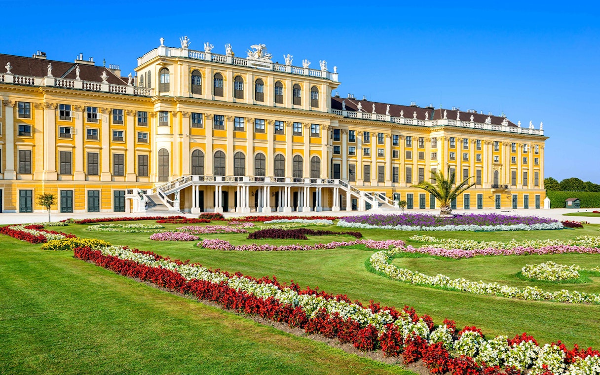 Schönbrunn Palace facade with vibrant gardens, Vienna.