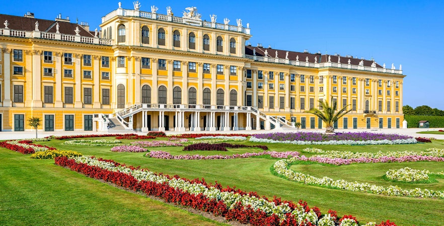 Schönbrunn Palace facade with vibrant gardens, Vienna.