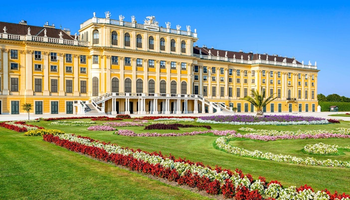 Schönbrunn Palace facade with vibrant gardens, Vienna.