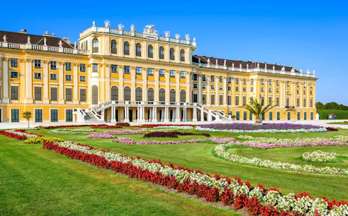 Schönbrunn Palace facade with vibrant gardens, Vienna.