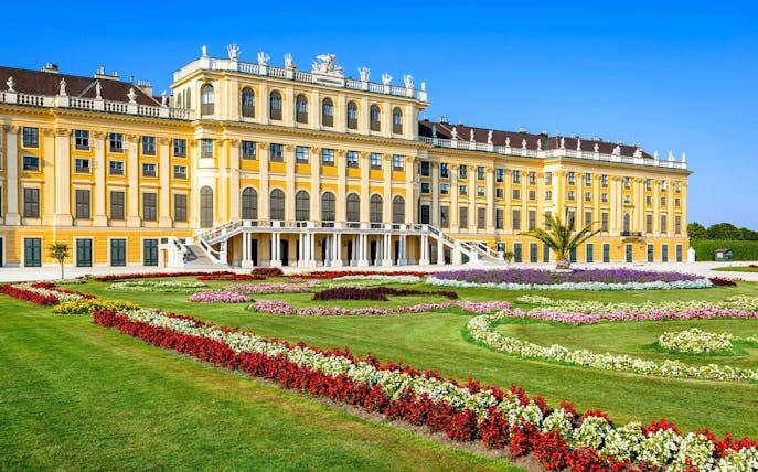 Schönbrunn Palace facade with vibrant gardens, Vienna.
