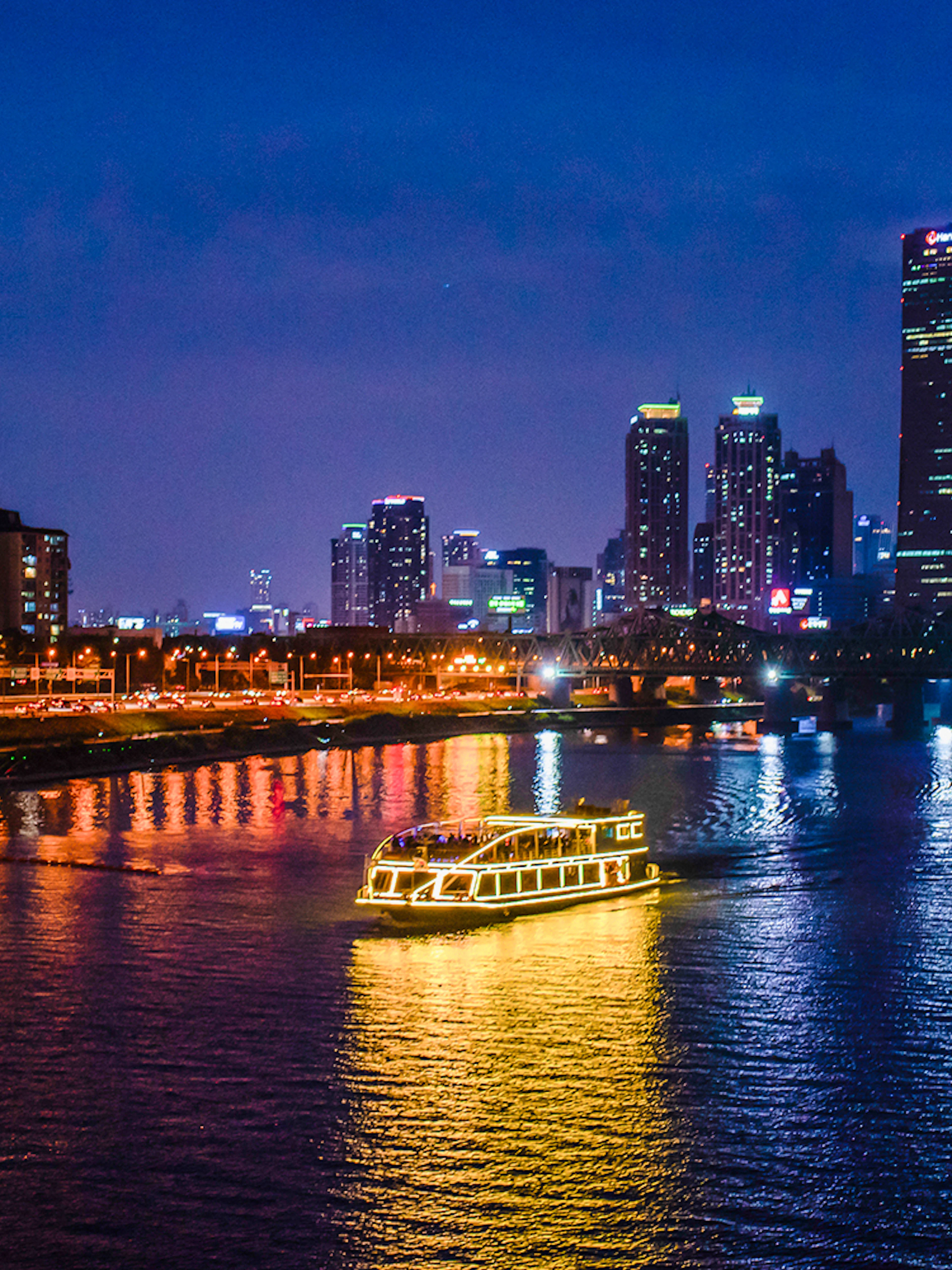 E-land ferry cruising on Han River with Seoul skyline in the background.