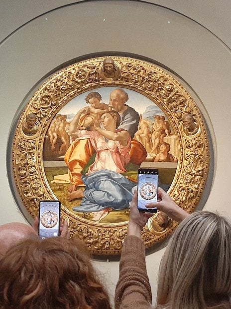 Visitors photographing Michelangelo's Holy Family at Uffizi Gallery, Florence.