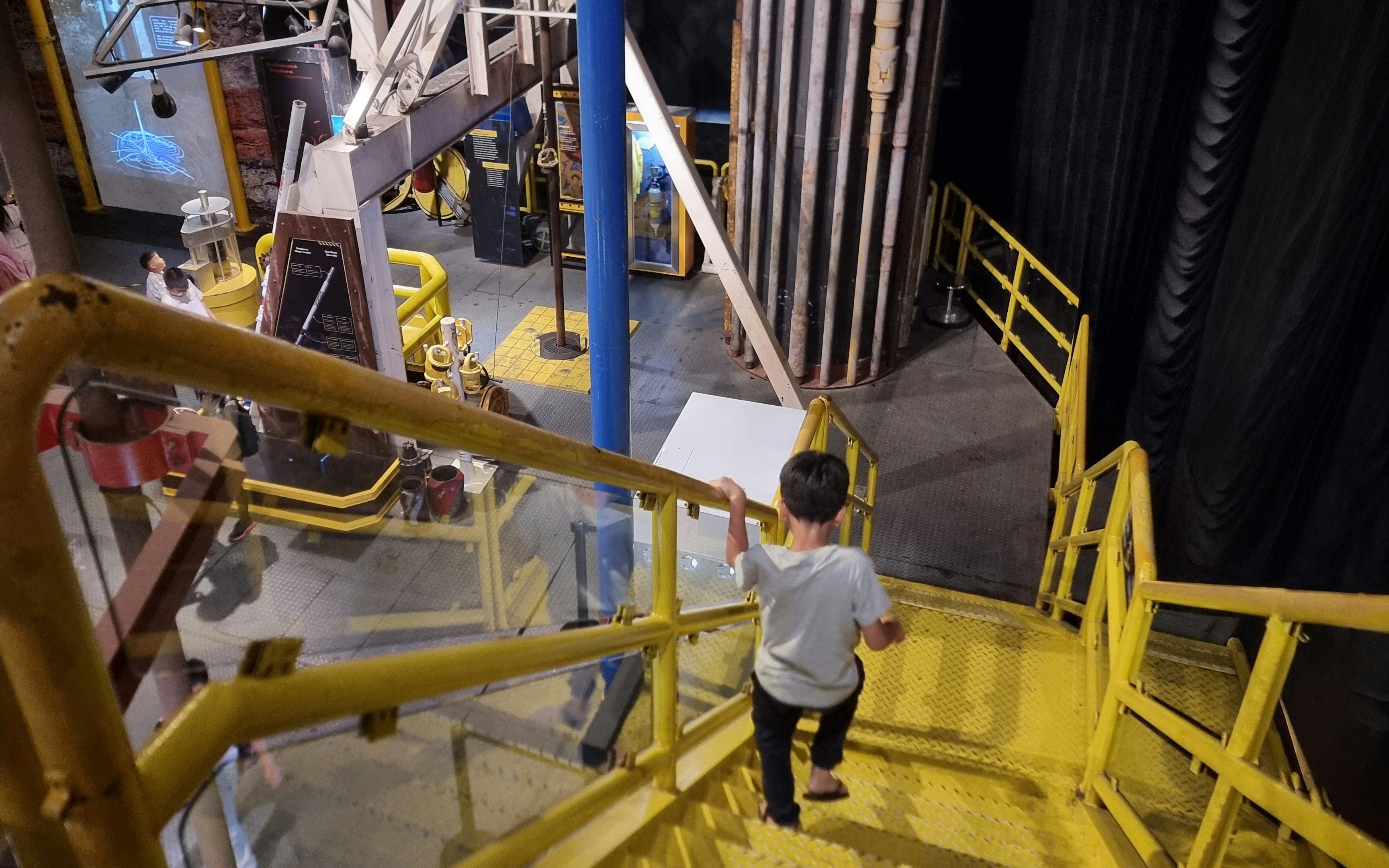 Child exploring oil rig exhibit at Petrosains.