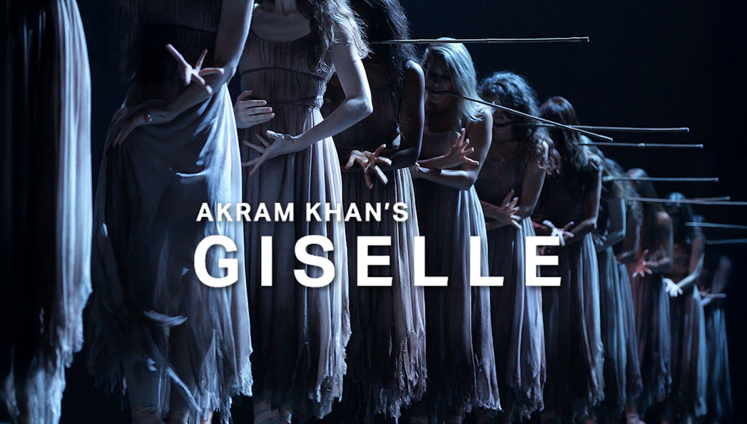 Dancers in Akram Khan's Giselle performing on stage in dim lighting.