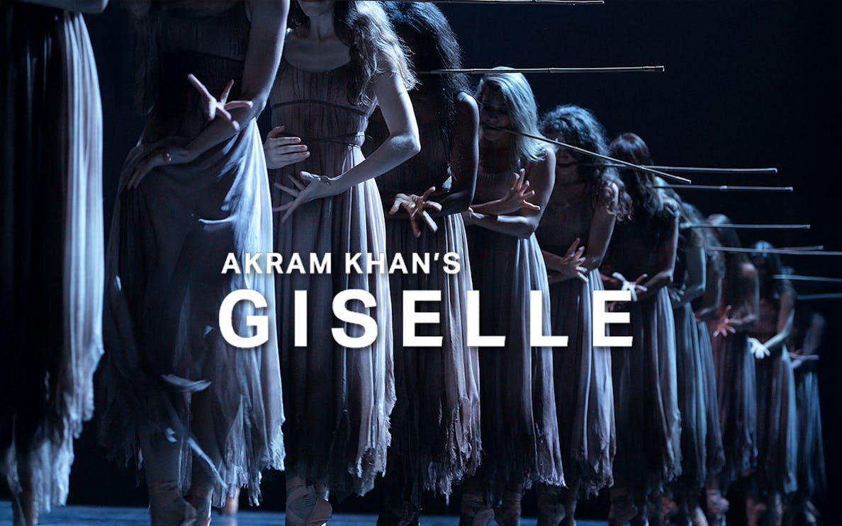 Dancers in Akram Khan's Giselle performing on stage in dim lighting.