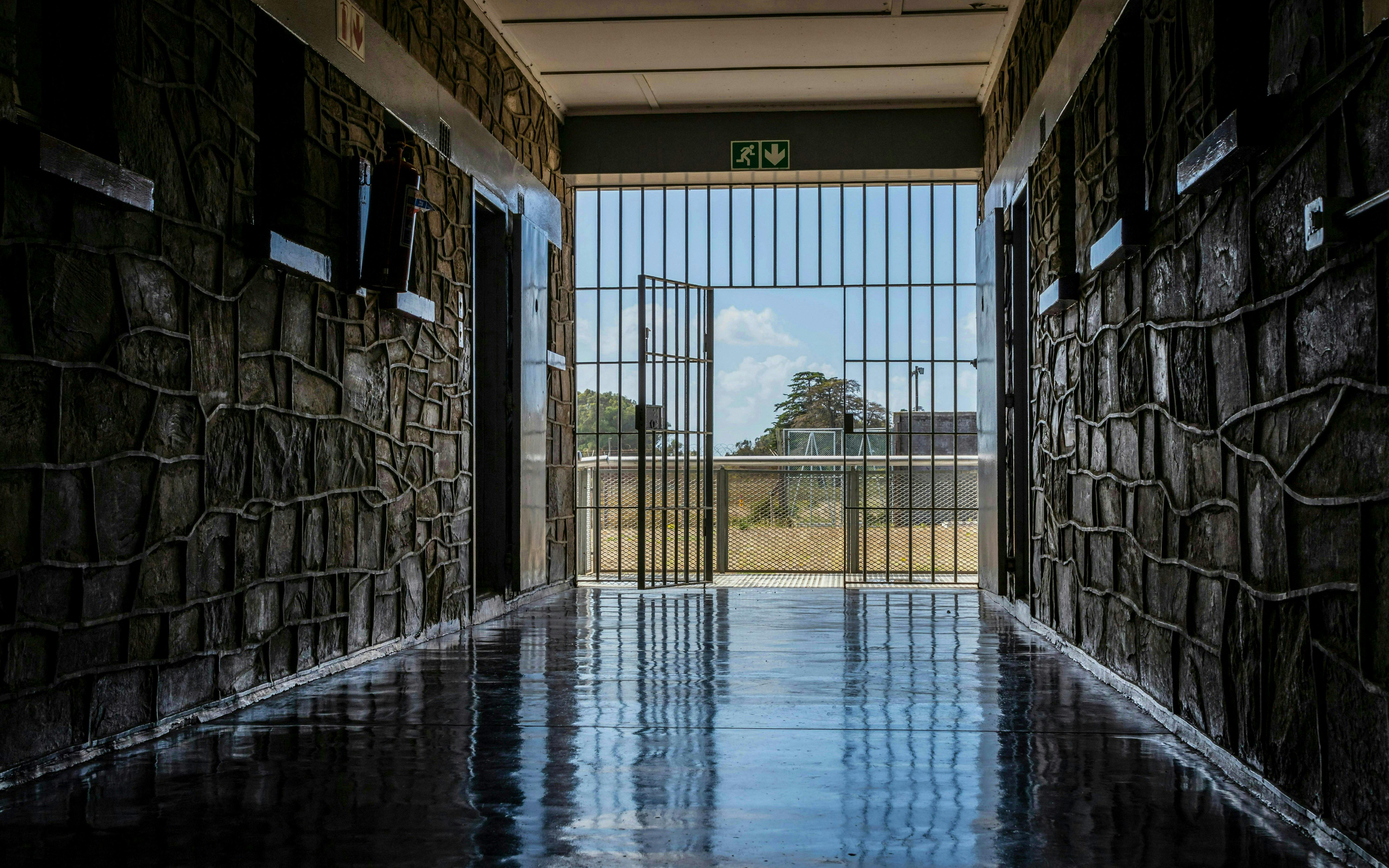 Corridor leading to open gate at Robben Island prison, South Africa.
