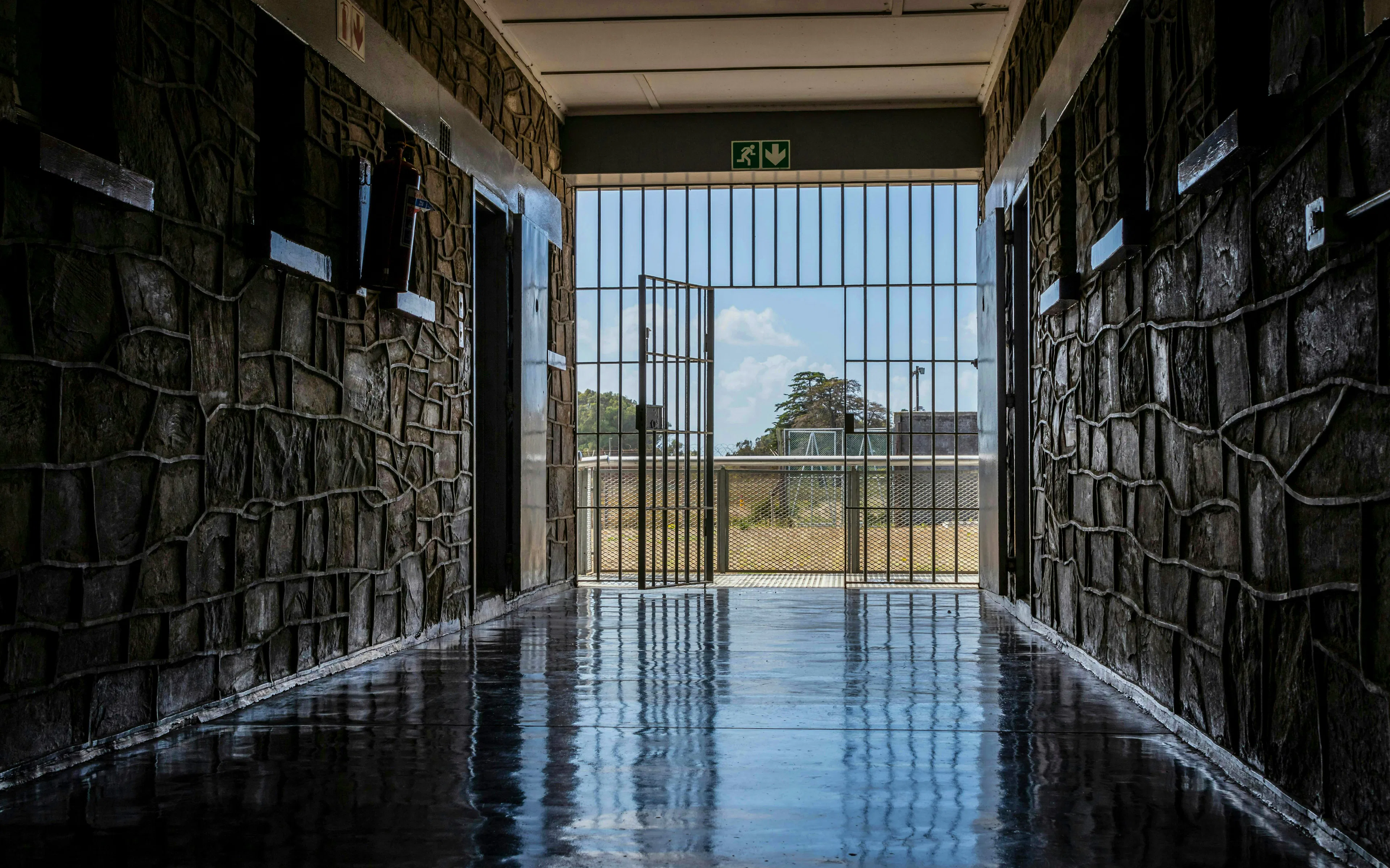 Corridor leading to open gate at Robben Island prison, South Africa.