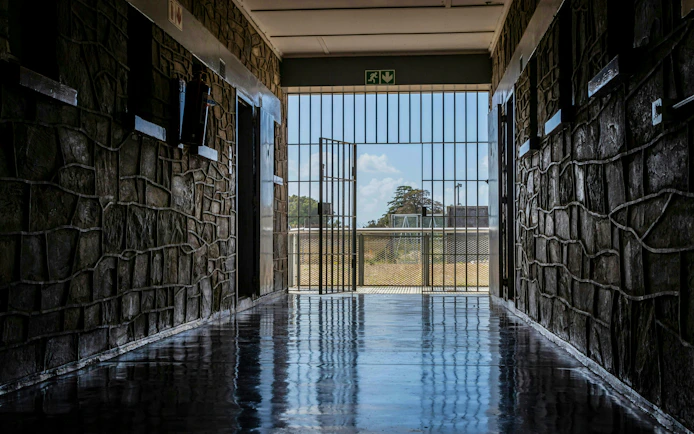 Corridor leading to open gate at Robben Island prison, South Africa.