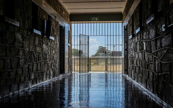 Corridor leading to open gate at Robben Island prison, South Africa.