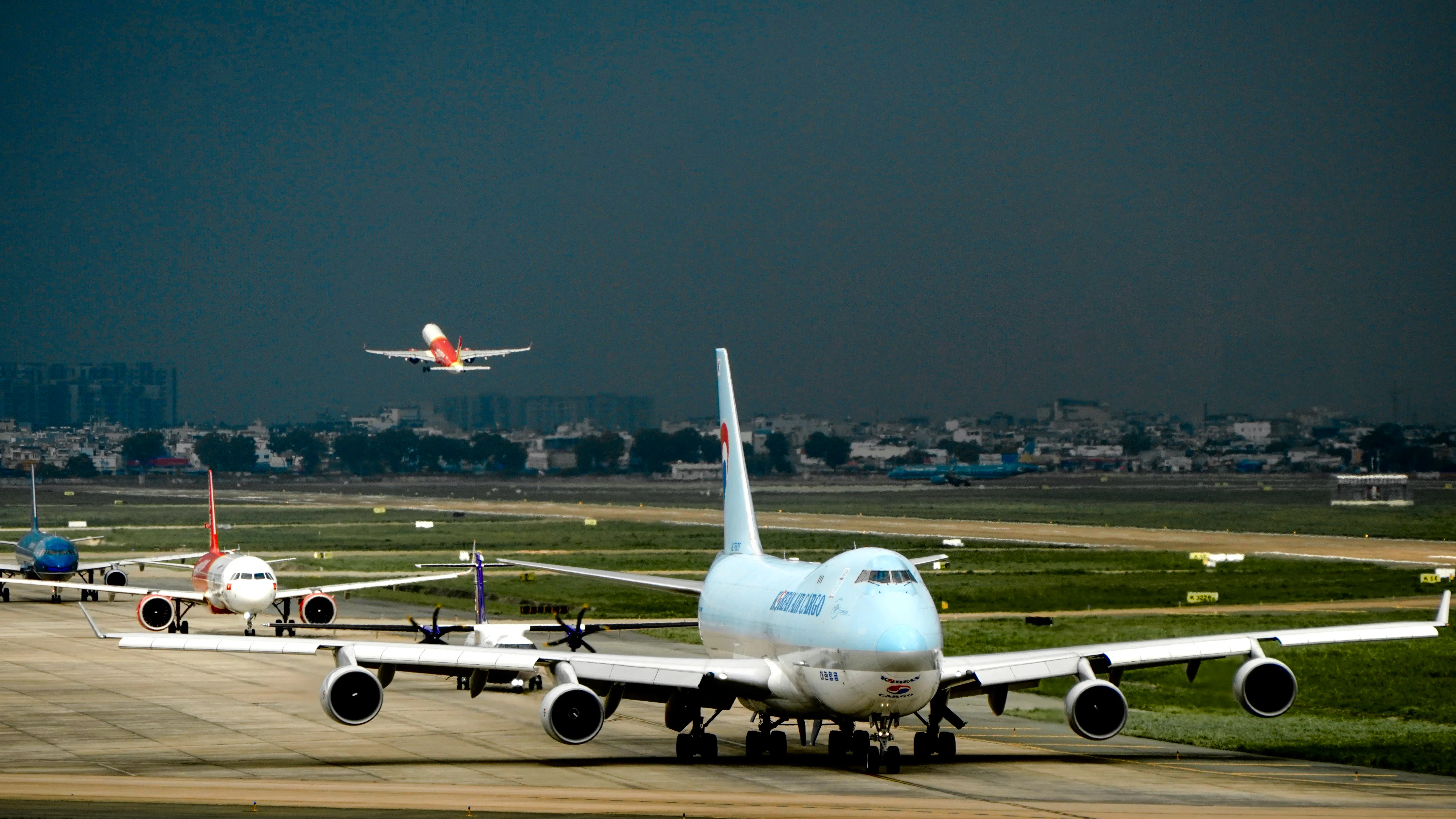 Planes taxiing and taking off at Ho Chi Minh Tan Son Nhat Airport.