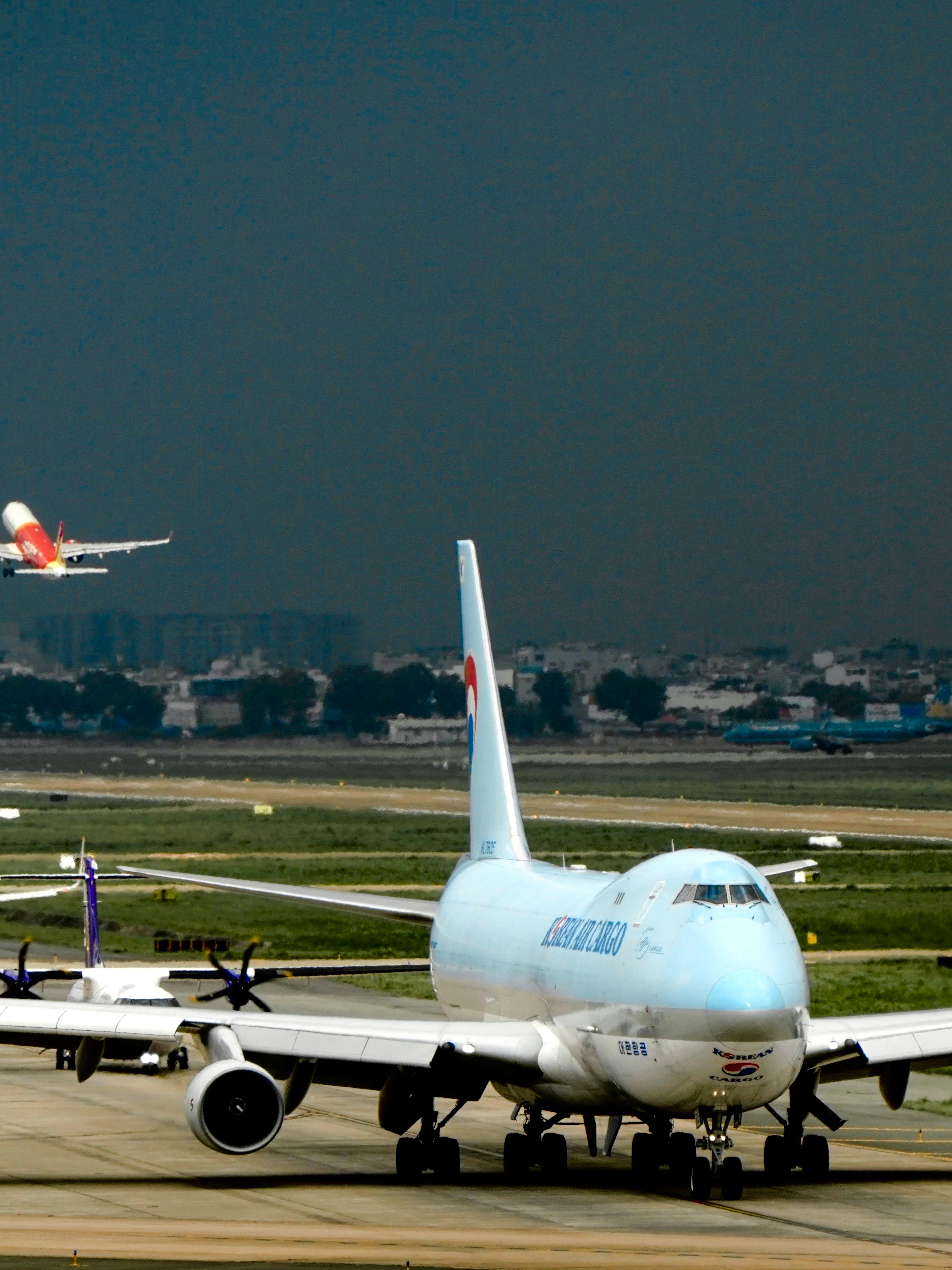 Planes taxiing and taking off at Ho Chi Minh Tan Son Nhat Airport.